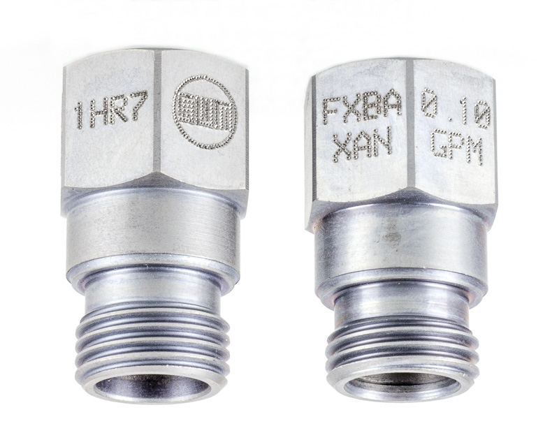 Marking model numbers and date codes on hydraulic cartridge valves.