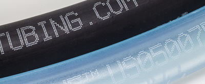 CIJ printing on flexible hose with black and white inks.
