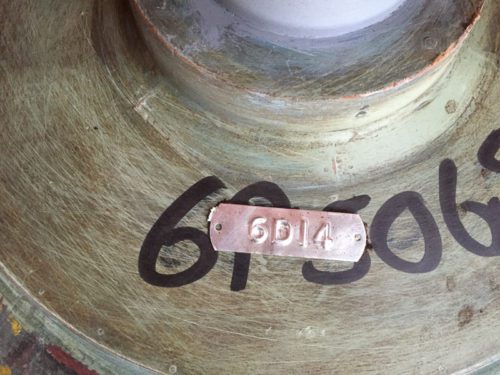 Metal Tag Adhered To Foundry Mold